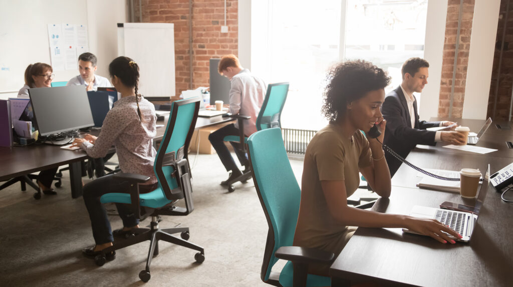 Ethernet Options Image, people working in an office on blue chairs.